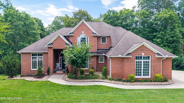 108 Center Park Ln, Oak Ridge, TN 37830 - traditional-style house with brick siding, a front yard, and a shingled roof