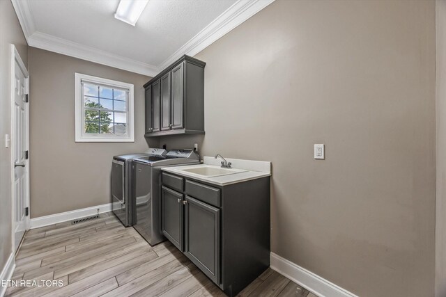 108 Center Park Ln, Oak Ridge, TN 37830 - laundry room featuring cabinet space, independent washer and dryer, ornamental molding, and light wood-style floors
