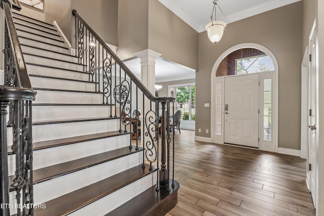 108 Center Park Ln, Oak Ridge, TN 37830 - foyer featuring a towering ceiling, crown molding, stairs, wood finished floors, and ornate columns