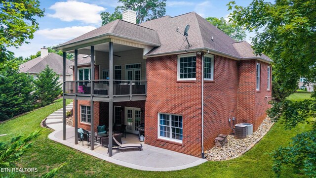 108 Center Park Ln, Oak Ridge, TN 37830 - back of property with a lawn, brick siding, a patio, roof with shingles, and a chimney