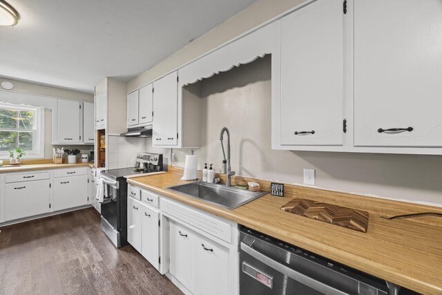 3205 Sylvia Rd, Dickson, TN 37055 - kitchen featuring appliances with stainless steel finishes, under cabinet range hood, dark wood-style flooring, white cabinets, and light countertops