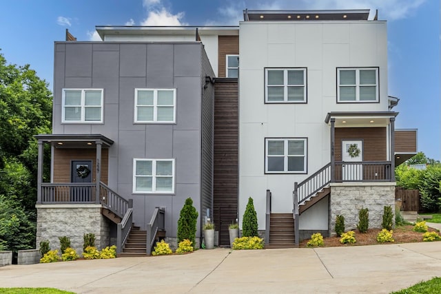 1227 N Avondale Cir, Nashville, TN 37207 - modern home featuring stairs, stucco siding, and stone siding