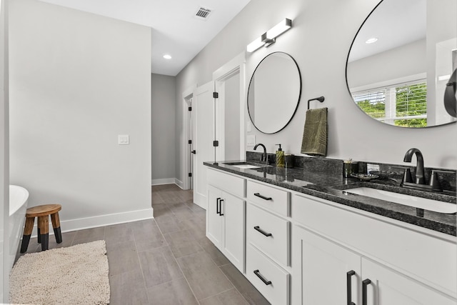 1227 N Avondale Cir, Nashville, TN 37207 - bathroom featuring double vanity, recessed lighting, and a soaking tub