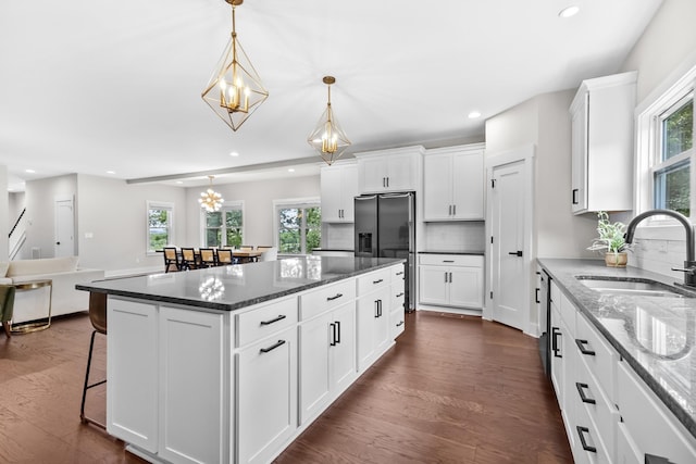 1227 N Avondale Cir, Nashville, TN 37207 - kitchen with stainless steel fridge, dark wood finished floors, a chandelier, recessed lighting, and a kitchen breakfast bar