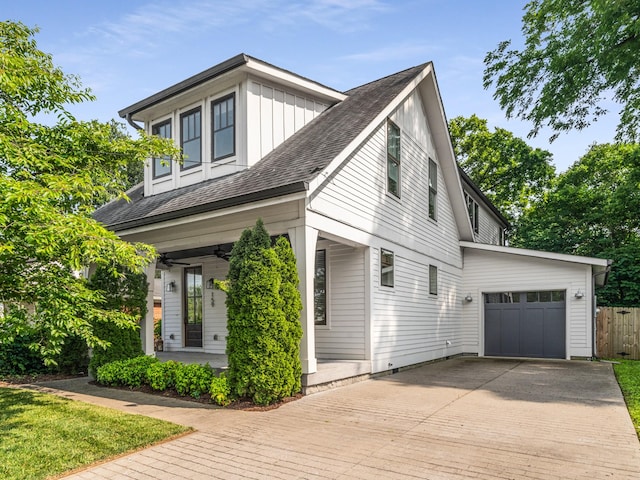 159 Acton St, Franklin, TN 37064 - view of side of home featuring decorative driveway, board and batten siding, a ceiling fan, a porch, and a garage