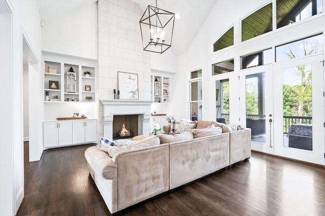 1542 Amesbury Ln, Franklin, TN 37069 - living area featuring high vaulted ceiling, plenty of natural light, a chandelier, a fireplace, and dark wood-style flooring