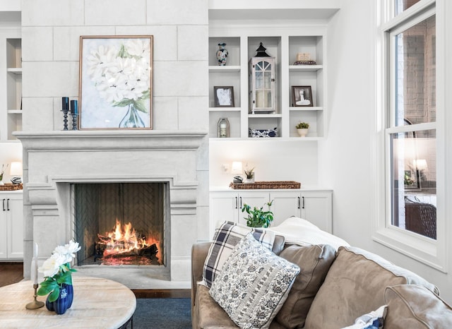 1542 Amesbury Ln, Franklin, TN 37069 - living area with a warm lit fireplace, healthy amount of natural light, and wood finished floors