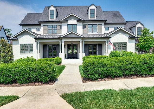 1542 Amesbury Ln, Franklin, TN 37069 - view of front of home featuring french doors, a standing seam roof, a shingled roof, and covered porch