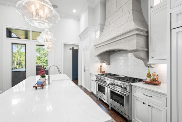 1542 Amesbury Ln, Franklin, TN 37069 - kitchen featuring double oven range, custom exhaust hood, crown molding, a chandelier, and white cabinets