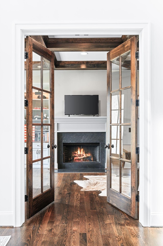 1542 Amesbury Ln, Franklin, TN 37069 - unfurnished living room with french doors, a fireplace with flush hearth, wood finished floors, and beamed ceiling