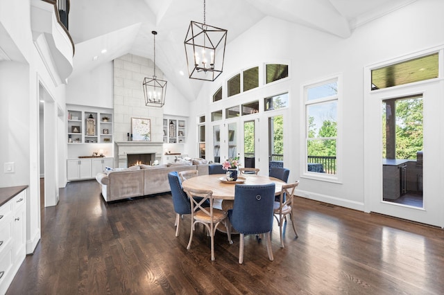 1542 Amesbury Ln, Franklin, TN 37069 - dining room featuring high vaulted ceiling, a lit fireplace, dark wood-style flooring, a chandelier, and built in shelves