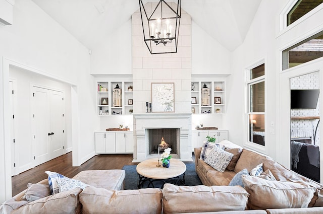 1542 Amesbury Ln, Franklin, TN 37069 - living room with high vaulted ceiling, dark wood finished floors, a large fireplace, and a chandelier