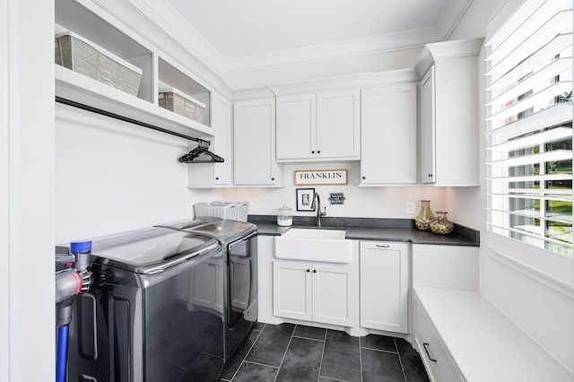 1542 Amesbury Ln, Franklin, TN 37069 - laundry room with cabinet space, washing machine and clothes dryer, crown molding, and dark tile patterned floors