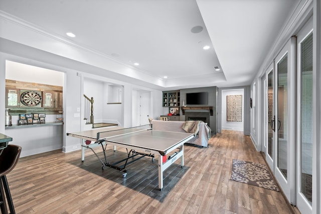 1542 Amesbury Ln, Franklin, TN 37069 - rec room featuring light wood-type flooring, a raised ceiling, a fireplace, recessed lighting, and crown molding