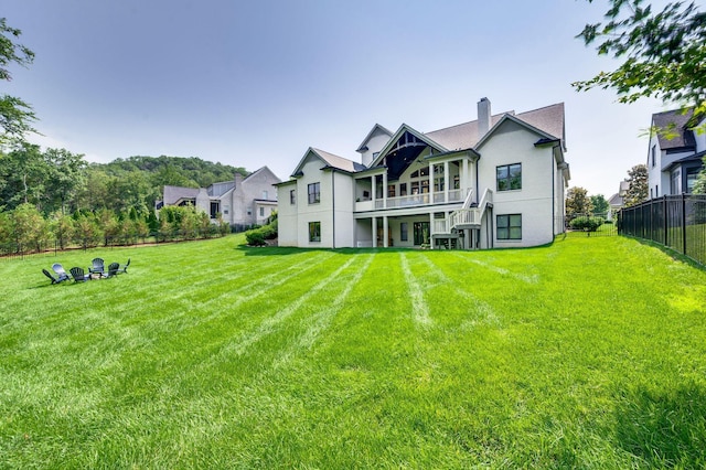 1542 Amesbury Ln, Franklin, TN 37069 - rear view of house with a balcony, a chimney, and stucco siding