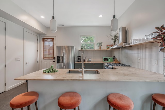 203 N 9th St Unit A/B, Nashville, TN 37206 - kitchen with appliances with stainless steel finishes, wall chimney exhaust hood, decorative backsplash, a peninsula, and light countertops