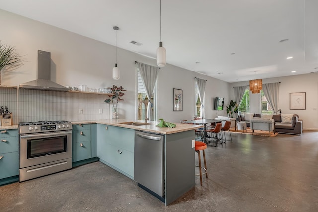 203 N 9th St Unit A/B, Nashville, TN 37206 - kitchen with appliances with stainless steel finishes, wall chimney range hood, plenty of natural light, open floor plan, and recessed lighting