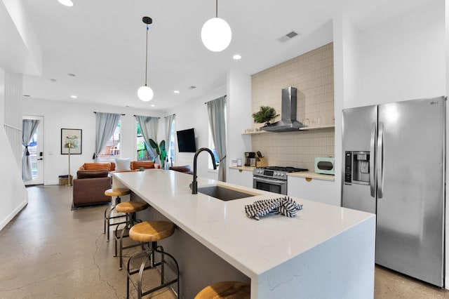 203 N 9th St Unit A/B, Nashville, TN 37206 - kitchen with appliances with stainless steel finishes, wall chimney exhaust hood, concrete floors, tasteful backsplash, and white cabinets