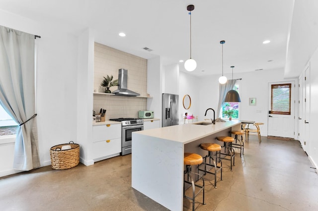 203 N 9th St Unit A/B, Nashville, TN 37206 - kitchen featuring stainless steel appliances, wall chimney exhaust hood, tasteful backsplash, a kitchen bar, and modern cabinets