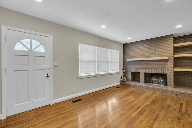 702 Marlboro Ave, Chattanooga, TN 37412 - unfurnished living room with wood finished floors, a fireplace, and recessed lighting