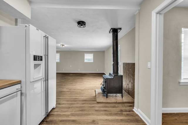702 Marlboro Ave, Chattanooga, TN 37412 - kitchen featuring white appliances, a wood stove, white cabinets, dark wood-type flooring, and open floor plan