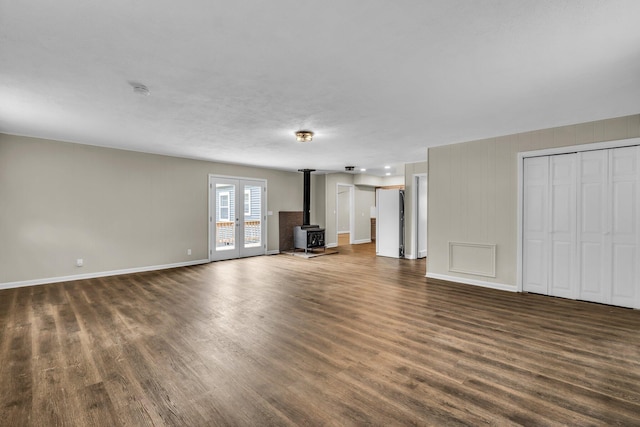 702 Marlboro Ave, Chattanooga, TN 37412 - unfurnished living room featuring a wood stove and dark wood-style flooring