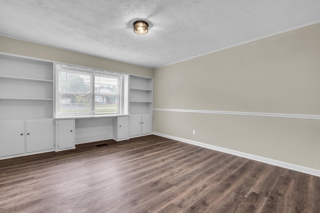 702 Marlboro Ave, Chattanooga, TN 37412 - unfurnished office with a textured ceiling, built in study area, wood finished floors, and built in shelves