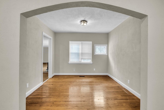 702 Marlboro Ave, Chattanooga, TN 37412 - empty room with wood finished floors, a textured ceiling, and a textured wall