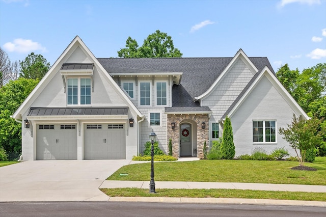 4141 Barnsley Loop, Ooltewah, TN 37363 - view of front of home with driveway, a front yard, stone siding, a standing seam roof, and a shingled roof