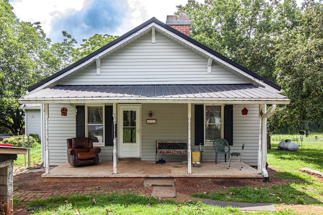 431 Haddon Ln, Winchester, TN 37398 - back of property with a porch, a chimney, a metal roof, and a lawn