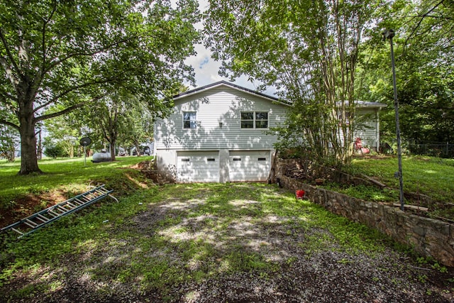 431 Haddon Ln, Winchester, TN 37398 - back of property with driveway, a lawn, and an attached garage