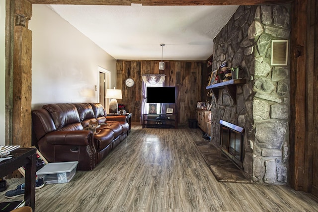 431 Haddon Ln, Winchester, TN 37398 - living area featuring wood finished floors, a stone fireplace, and wooden walls