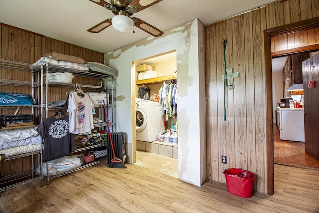 431 Haddon Ln, Winchester, TN 37398 - bedroom with wood finished floors, wood walls, washer and clothes dryer, and ceiling fan