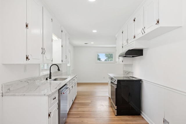 415 Porter Cir, Columbia, TN 38401 - kitchen featuring electric stove, stainless steel dishwasher, under cabinet range hood, light wood-type flooring, and white cabinetry