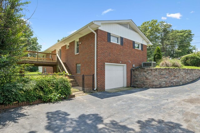 415 Porter Cir, Columbia, TN 38401 - view of side of property with a garage, a gate, brick siding, asphalt driveway, and a deck