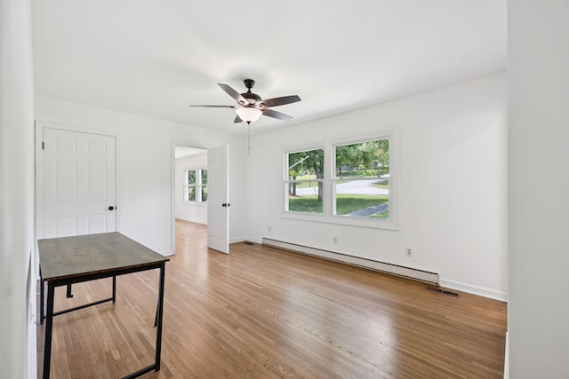 415 Porter Cir, Columbia, TN 38401 - spare room featuring baseboard heating, a ceiling fan, and wood finished floors