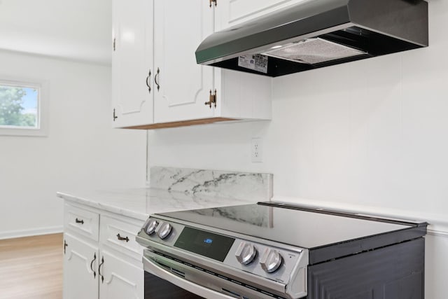 415 Porter Cir, Columbia, TN 38401 - kitchen featuring exhaust hood, electric range, white cabinetry, light stone countertops, and light wood-style flooring