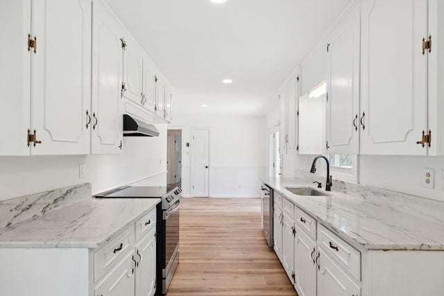 415 Porter Cir, Columbia, TN 38401 - kitchen with range with electric stovetop, light wood finished floors, white cabinets, under cabinet range hood, and dishwasher