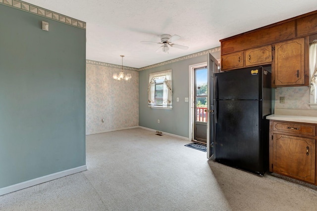303 Furnace Hollow Rd, Dickson, TN 37055 - kitchen with freestanding refrigerator, ceiling fan, brown cabinetry, light colored carpet, and wallpapered walls
