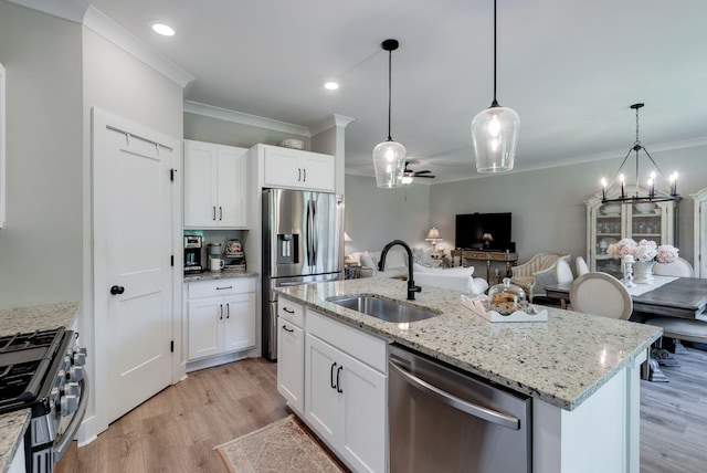 588 Davis Valley Dr, Columbia, TN 38401 - kitchen with stainless steel appliances, ornamental molding, open floor plan, light wood finished floors, and hanging light fixtures