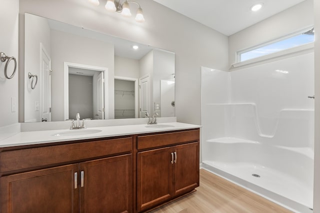 15 Aurora Cir, Fayetteville, TN 37334 - bathroom with double vanity, wood finished floors, a spacious closet, and a shower
