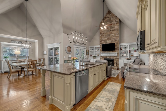 122 Ridgebend Dr, Murfreesboro, TN 37128 - kitchen with cream cabinets, dishwasher, high vaulted ceiling, a fireplace, and a ceiling fan