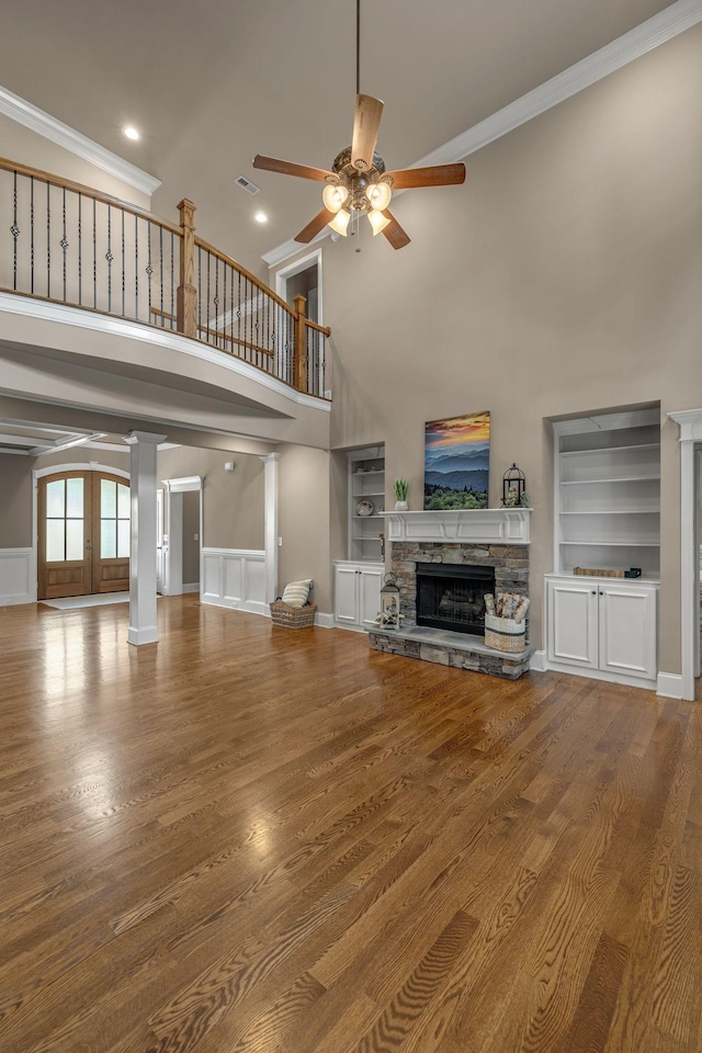 122 Ridgebend Dr, Murfreesboro, TN 37128 - unfurnished living room with a ceiling fan, built in features, a fireplace, a towering ceiling, and wood finished floors