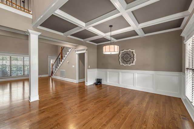 122 Ridgebend Dr, Murfreesboro, TN 37128 - unfurnished dining area featuring ornate columns, coffered ceiling, stairs, beam ceiling, and wood finished floors