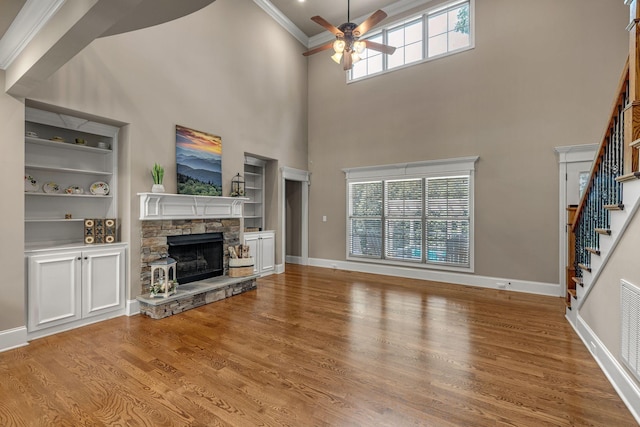 122 Ridgebend Dr, Murfreesboro, TN 37128 - unfurnished living room with a ceiling fan, ornamental molding, wood finished floors, a fireplace, and stairs