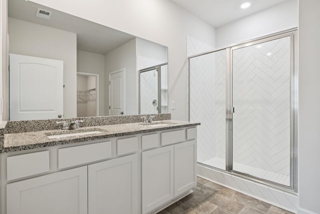 8044 Typhani Way, White House, TN 37188 - bathroom with a stall shower, double vanity, a walk in closet, and recessed lighting