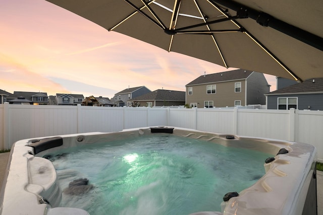 8044 Typhani Way, White House, TN 37188 - pool at dusk with a hot tub, a residential view, and a fenced backyard