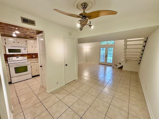 214 Old Hickory Blvd Unit 132, Nashville, TN 37221 - kitchen with white appliances, light tile patterned floors, french doors, white cabinetry, and ceiling fan