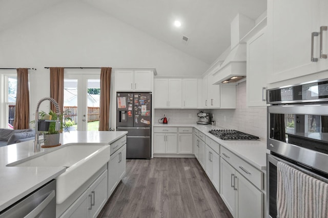 373 Hammock Ln, Spring Hill, TN 37174 - kitchen with appliances with stainless steel finishes, custom range hood, light countertops, decorative backsplash, and white cabinetry