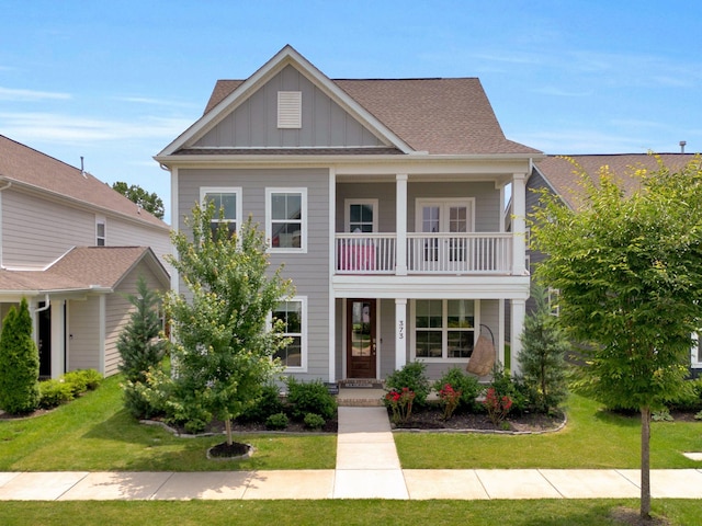 373 Hammock Ln, Spring Hill, TN 37174 - view of front facade with a balcony, board and batten siding, a front yard, and a porch